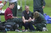 8 January 2000; Ronan O'Gara receives treatment for an ankle injury from team physiotherapist Denise Fanagan and massur Willie Bennett during Ireland Rugby Squad Training, in Toronto, Ontario, Canada. Photo by Matt Browne/Sportsfile