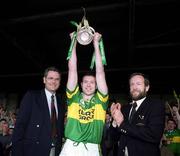 16 July 2000; Kerry captain Seamus Moyniham lifts the cup, watched by Tim O'Neill, Bank of Ireland, left, and Sean Kelly, Chairman of Munster Council,  following the Bank of Ireland Munster Senior Football Championship Final between Kerry and Clare at the Gaelic Grounds in Limerick. Photo by Ray Lohan/Sportsfile