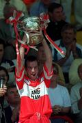 16 July 2000; Sean McKenna of Derry lifts the Fr Murray Cup following the Ulster Minor Football Championship Final match between Tyrone and Derry at St Tiernach's Park in Clones, Monaghan. Photo by David Maher/Sportsfile