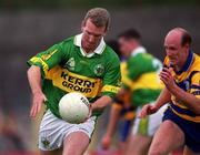 16 July 2000; Mike Hassett of Kerry in action against Donal O'Sullivan of Clare during the Bank of Ireland Munster Senior Football Championship Final between Kerry and Clare at the Gaelic Grounds in Limerick. Photo By Brendan Moran/Sportsfile