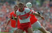 16 July 2000; Anthony Tohill of Derry in action against Justin McNulty and Paul McGrane of Armagh during the Bank of Ireland Ulster Senior Football Championship Final match between Armagh and Derry at St Tiernach's Park in Clones, Monaghan. Photo by David Maher/Sportsfile