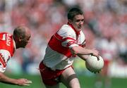 16 July 2000; Joseph Cassidy of Derry in action against Gerard Reid of Armagh during the Bank of Ireland Ulster Senior Football Championship Final match between Armagh and Derry at St Tiernach's Park in Clones, Monaghan. Photo by Damien Eagers/Sportsfile