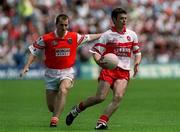 16 July 2000; Paul McFlynn of Derry in action against Paddy McKeever of Armagh during the Bank of Ireland Ulster Senior Football Championship Final match between Armagh and Derry at St Tiernach's Park in Clones, Monaghan. Photo by Damien Eagers/Sportsfile