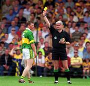 16 July 2000; Referee John Bannon shows a yellow card to Tomas O'Se of Kerry during the Bank of Ireland Munster Senior Football Championship Final between Kerry and Clare at the Gaelic Grounds in Limerick. Photo By Brendan Moran/Sportsfile