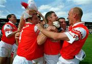 16 July 2000; Armagh players from left, Justin McNulty, Ger Houlahan and Gerard Reid celebrate following the Bank of Ireland Ulster Senior Football Championship Final match between Armagh and Derry at St Tiernach's Park in Clones, Monaghan. Photo by Damien Eagers/Sportsfile