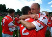 16 July 2000; Armagh players Enda McNulty, left, and Gerard Reid celebrate following the Bank of Ireland Ulster Senior Football Championship Final match between Armagh and Derry at St Tiernach's Park in Clones, Monaghan. Photo by David Maher/Sportsfile