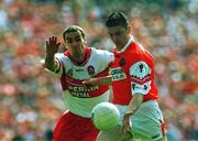 16 July 2000; Oisin McConville of Armagh in action against Sean Martin Lockhart of Derry during the Bank of Ireland Ulster Senior Football Championship Final match between Armagh and Derry at St Tiernach's Park in Clones, Monaghan. Photo by David Maher/Sportsfile