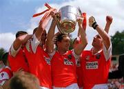 16 July 2000; Armagh captain Kieran McGeeny, centre, lifts the Anglo Celt Cup surrounded by team-mates following the Bank of Ireland Ulster Senior Football Championship Final match between Armagh and Derry at St Tiernach's Park in Clones, Monaghan. Photo by Damien Eagers/Sportsfile