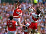 16 July 2000; Gary Coleman of Derry in action against Cathal O'Rourke of Armagh, as Paddy McKeever of Armagh watches on during the Bank of Ireland Ulster Senior Football Championship Final match between Armagh and Derry at St Tiernach's Park in Clones, Monaghan. Photo by Damien Eagers/Sportsfile