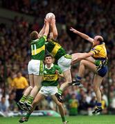 16 July 2000; Liam Hassett, left, and Dara O'Se of Kerry field a high ball under pressure from Donal O'Sullivan of Clare during the Bank of Ireland Munster Senior Football Championship Final between Kerry and Clare at the Gaelic Grounds in Limerick. Photo By Brendan Moran/Sportsfile