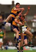 16 July 2000; Ronan Slattery of Clare claims a high ball ahead of team-mate David Russell and Aodan MacGearailt of Kerry during the Bank of Ireland Munster Senior Football Championship Final between Kerry and Clare at the Gaelic Grounds in Limerick. Photo by Ray Lohan/Sportsfile