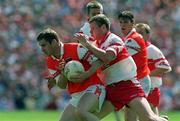 16 July 2000; Tony McEntee of Armagh in action against Niall McCusker of Derry during the Bank of Ireland Ulster Senior Football Championship Final match between Armagh and Derry at St Tiernach's Park in Clones, Monaghan. Photo by David Maher/Sportsfile