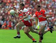 16 July 2000; Joseph Cassidy of Derry in action against Kieran McGeeney of Armagh during the Bank of Ireland Ulster Senior Football Championship Final match between Armagh and Derry at St Tiernach's Park in Clones, Monaghan. Photo by David Maher/Sportsfile