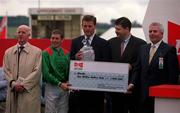 2 July 2000; Jockey Johnny Murtagh, who won The Budweiser Irish Derby on Sinndar with winning trainer John Oxx, are presented with a cheque at The Curragh Racecourse in Newbridge, Kildare. Photo by Damien Eagers/Sportsfile