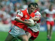 16 July 2000; Paddy McKeever of Armagh in action against Paul McFlynn of Derry during the Bank of Ireland Ulster Senior Football Championship Final match between Armagh and Derry at St Tiernach's Park in Clones, Monaghan. Photo by Damien Eagers/Sportsfile