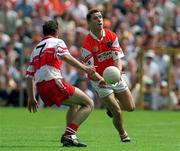 16 July 2000; Paul McGrane of Armagh in action against Paul McFlynn of Derry during the Bank of Ireland Ulster Senior Football Championship Final match between Armagh and Derry at St Tiernach's Park in Clones, Monaghan. Photo by Damien Eagers/Sportsfile