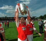 16 July 2000; Tony McEntee of Armagh celebrates with the Anglo Celt Cup following the Bank of Ireland Ulster Senior Football Championship Final match between Armagh and Derry at St Tiernach's Park in Clones, Monaghan. Photo by David Maher/Sportsfile