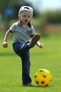 7 June 2008; Two and a half-year-old Karl Delahunty, from Ashbourne, Co Meath, tries kicking the ball on the sideline during the Danone Nations Cup National Finals, AUL Complex, Clonshaugh, Dublin. Picture credit: Ray McManus / SPORTSFILE