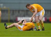 10 May 2015; Aaron Graffin,, Antrim, holds his knee after sustaining a serious injury as team-mate Neal McAuley helps his team-mate before being carried off by medical personal. Leinster GAA Hurling Senior Championship Qualifier Group, round 2, Westmeath v Antrim. Cusack Park, Mullingar, Co. Westmeath. Picture credit: David Maher / SPORTSFILE