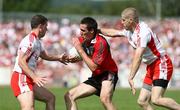 8 June 2008; Dan Gordon, Down, in action against Colin Holmes and Kevin Hughes, Tyrone. GAA Football Ulster Senior Championship Quarter-Final, Tyrone v Down, Healy Park, Omagh, Co. Tyrone. Picture credit: Oliver McVeigh / SPORTSFILE