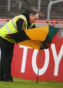 21 June 2008; A steward wrestles with an umbrella during blustery conditions. Ulster GAA Senior Football Championship Semi Final, Derry v Fermanagh, Healy Park, Omagh, Co. Tyrone. Picture credit: Oliver McVeigh / SPORTSFILE