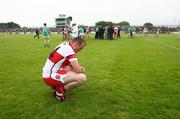 21 June 2008; A dejected Paddy Bradley, Derry, looks toward the ground as the Fermanagh players celebrate in the background. Ulster GAA Senior Football Championship Semi Final, Derry v Fermanagh, Healy Park, Omagh, Co. Tyrone. Picture credit: Oliver McVeigh / SPORTSFILE