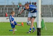 16 May 2015; Three year old Timmy Sheehan scores a goal past his father, Laois footballer Billy Sheehan after the game. Leinster GAA Football Senior Championship, Round 1, Carlow v Laois, Netwatch Cullen Park, Carlow. Picture credit: Matt Browne / SPORTSFILE