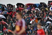 17 May 2015; Supporters watch on during a rain shower during the first half. Leinster GAA Football Senior Championship, Round 1, Louth v Westmeath. County Grounds, Drogheda, Co, Louth. Picture credit: Ramsey Cardy / SPORTSFILE