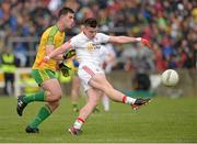 17 May 2015; Connor McAliskey, Tyrone, scores a second half point despite the attention of Patrick McBrearty, Donegal. Ulster GAA Football Senior Championship, Preliminary Round, Donegal v Tyrone. MacCumhaill Park, Ballybofey, Co. Donegal. Picture credit: Oliver McVeigh / SPORTSFILE