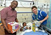 18 May 2015; Liffey Wanderers' Anthony O'Connor with Rebecca Oyekan, age 2, and her father William, from Blanchardstown, Co. Dublin, and the FAI Junior Cup trophy during a visit to Temple Street Hospital, Temple Street Hospital, Dublin. Picture credit: Cody Glenn / SPORTSFILE