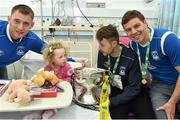 18 May 2015; Liffey Wanderers players, from left to right, Gary Young, Paul Gannon and Anthony O'Connor with Abby Egan, age 3, of Finglas, Co. Dublin, and the FAI Junior Cup trophy during a visit to Temple Street Hospital, Temple Street Hospital, Dublin. Picture credit: Cody Glenn / SPORTSFILE