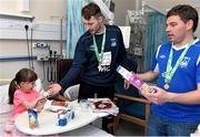 18 May 2015; Liffey Wanderers player Paul Gannon, and Anthony O'Connor, right, with Danika Melia, age 8, from Santry, Co. Dublin, a gift during a visit to Temple Street Hospital, Temple Street Hospital, Dublin. Picture credit: Cody Glenn / SPORTSFILE