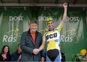 18 May 2015; Matthew Quinlan, chairman Tipperary Co-Op, presenting Ian Richardson, UCD, with the Cuchulainn statue for the first county rider home in Stage 2 of the 2015 An Post Rás. Carlow - Tipperary. Photo by Sportsfile