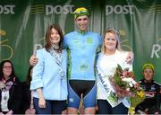 18 May 2015; Ian Richardson, UCD, after receiving the One Direct County Jersey, from Rose McManus, left, Marketing Manager, One Direct, and Miss An Post Rás Tracy Byrne, following Stage 2 of the 2015 An Post Rás. Carlow - Tipperary. Photo by Sportsfile