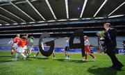 30 June 2008; Pól O'Gallchóir, Ceannasai, TG4, follows children carrying TG4 branding out on to the field at the TG4 All-Ireland Ladies Football Championship Launch. Croke Park, Dublin. Photo by Sportsfile