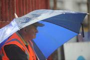 6 July 2008; A steward takes shelter from the rain during half-time. GAA Football Munster Senior Championship Final, Kerry v Cork, Pairc Ui Chaoimh, Cork. Picture credit: Stephen McCarthy / SPORTSFILE