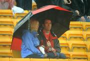 6 July 2008; Supporters take shelter from the rain during half-time. GAA Football Munster Senior Championship Final, Kerry v Cork, Pairc Ui Chaoimh, Cork. Picture credit: Stephen McCarthy / SPORTSFILE