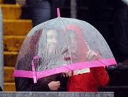 6 July 2008; Cork supporters shelter under an umbrella while watching the game. GAA Football Munster Senior Championship Final, Kerry v Cork, Pairc Ui Chaoimh, Cork. Picture credit: Brendan Moran / SPORTSFILE