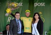 22 May 2015; Lukas Postlberger, Tirol Cycling Team, after receiving the An Post Rás Yellow Jersey Classification, from Miss An Post Sinead Flynn and Colm Conlon, Delivery Services Manager, An Post Carrick-on-Shannon, following Stage 6 of the 2015 An Post Rás. Ballina - Ballinamore. Photo by Sportsfile