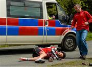 24 May 2015; Sean Featherstone, Newry Wheelers, lies on the ground after beng involved in an accident during Stage 8 of the 2015 An Post Rás. Drogheda - Skerries. Photo by Sportsfile