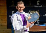 24 May 2015; Jockey Kevin Manning holds up the trophy after winning the Tattersalls Irish 1,000 Guineas on Pleascach. Curragh Racecourse, The Curragh, Co. Kildare. Picture credit: Cody Glenn / SPORTSFILE