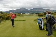 25 May 2015; Rory McIlroy hits a drive from the 18th tee box, watched by caddie JP Fitzgerald and coach Michael Bannon, during a practice round. Dubai Duty Free Irish Open Golf Championship 2015, Practice Day 1. Royal County Down Golf Club, Co. Down. Picture credit: Oliver McVeigh / SPORTSFILE