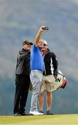 25 May 2015; Graeme McDowell taking a selfie of himself with coach Pete Cowen, left, and Ken Comboy, Caddie, right, during a practice round. Dubai Duty Free Irish Open Golf Championship 2015, Practice Day 1. Royal County Down Golf Club, Co. Down. Picture credit: Oliver McVeigh / SPORTSFILE