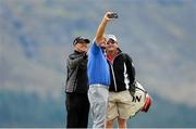 25 May 2015; Graeme McDowell taking a selfie of himself with coach Pete Cowen, left, and Ken Comboy, Caddie, right, during a practice round. Dubai Duty Free Irish Open Golf Championship 2015, Practice Day 1. Royal County Down Golf Club, Co. Down. Picture credit: Oliver McVeigh / SPORTSFILE