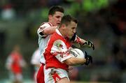 4 June 2000; Paddy McKeever of Armagh in action against Colin Holmes of Tyrone during the Bank of Ireland Ulster Senior Football Championship Quarter-Final match between Tyrone and Armagh at St Tiernach's Park in Clones, Monaghan. Photo by Brendan Moran/Sportsfile