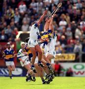 28 May 2000; Waterford's Peter Queally, left, and James Murray in action against Mark O'Leary of Tipperary during the Guinness Munster Senior Hurling Championship Quarter-Final between Tipperary and Waterford at Páirc Uí Chaoimh in Cork. Photo by Brendan Moran/Sportsfile