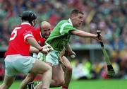 4 June 2000; Ciaran Carey of Limerick bursts past Cork defenders Wayne Sherlock, 5, and Brian Corcoran during the Guinness Munster Senior Hurling Championship Semi-Final match between Cork and Limerick at Semple Stadium in Thurles, Tipperary. Photo by Ray McManus/Sportsfile