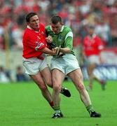 4 June 2000; Michael O'Connell of Cork in action against  Limerick's Mark Foley during the Guinness Munster Senior Hurling Championship Semi-Final match between Cork and Limerick at Semple Stadium in Thurles, Tipperary. Photo by Ray McManus/Sportsfile