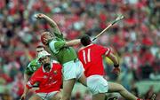 4 June 2000; Ollie Moran of Limerick gains possession under pressure from Fergal McCormack of Cork, 11, during the Guinness Munster Senior Hurling Championship Semi-Final match between Cork and Limerick at Semple Stadium in Thurles, Tipperary. Photo by Ray McManus/Sportsfile