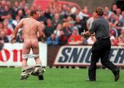 23 July 2000; West Ham United manager Harry Redknapp chases after a streaker with a bottle of water during the Pre-Season Friendly match between St Patrick's Athletic and West Ham United at Richmond Park in Dublin. Photo by David Maher/Sportsfile